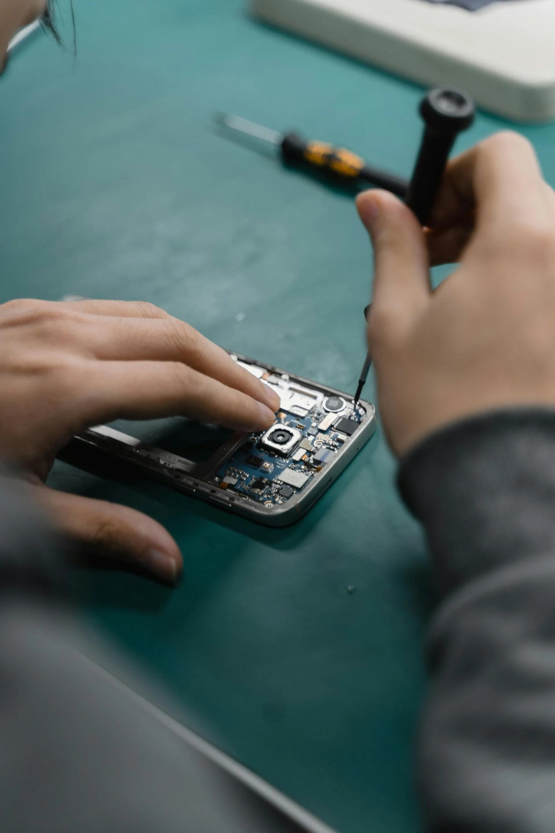 Close-up of a phone motherboard during repair